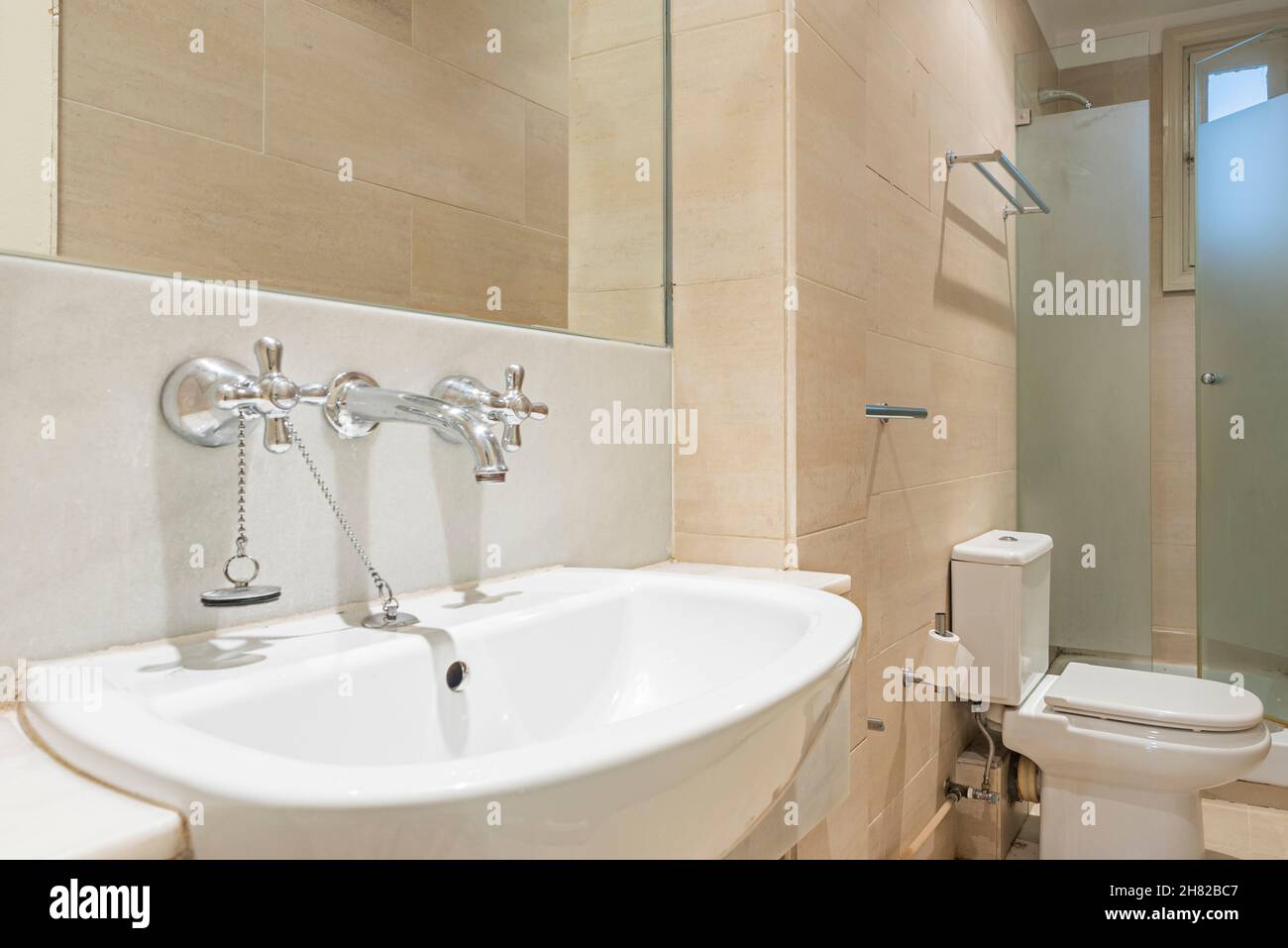 Sink with individual taps for hot and cold water in a bathroom with