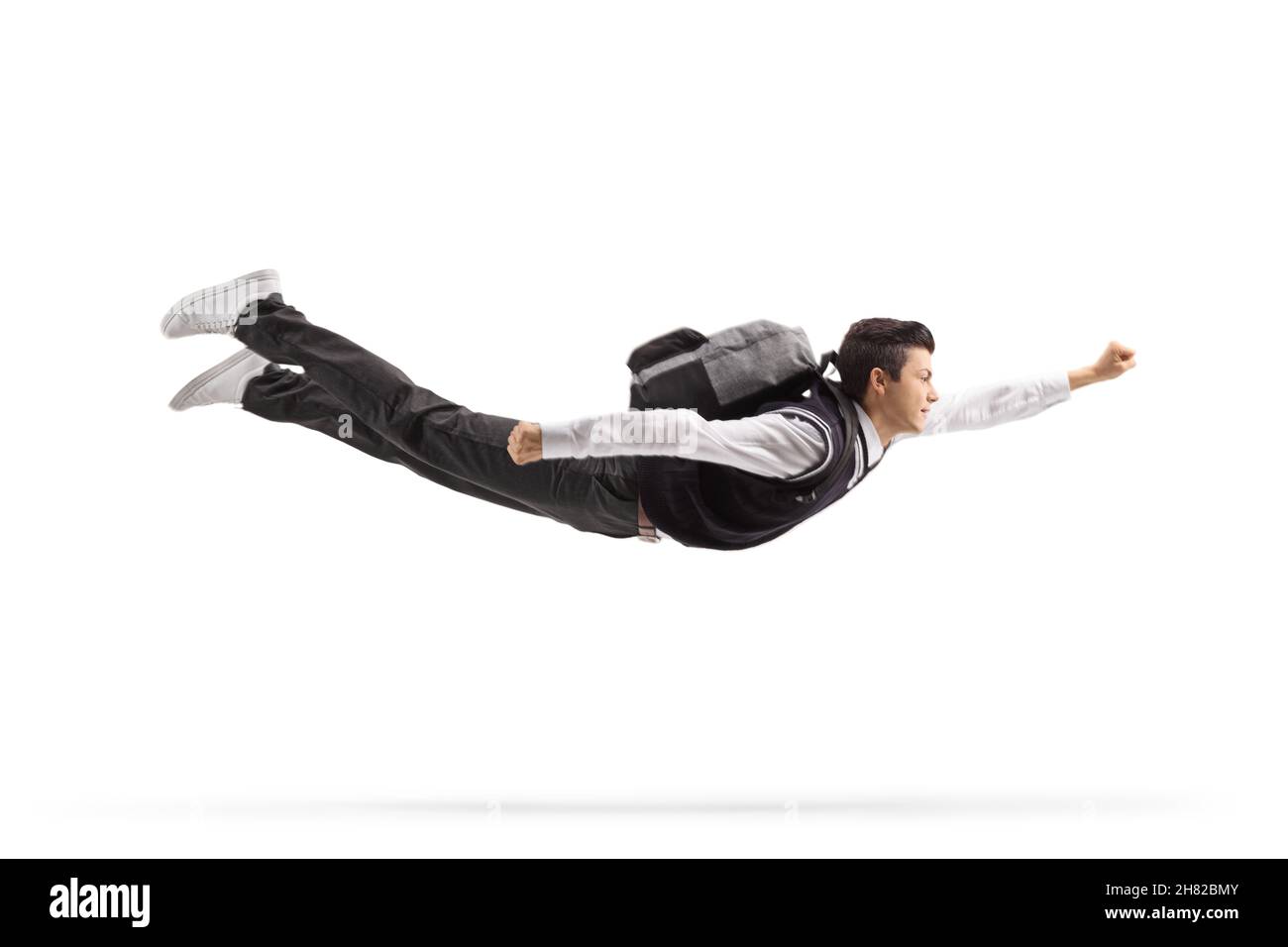 Teenage male student with a backpack flying isolated on white