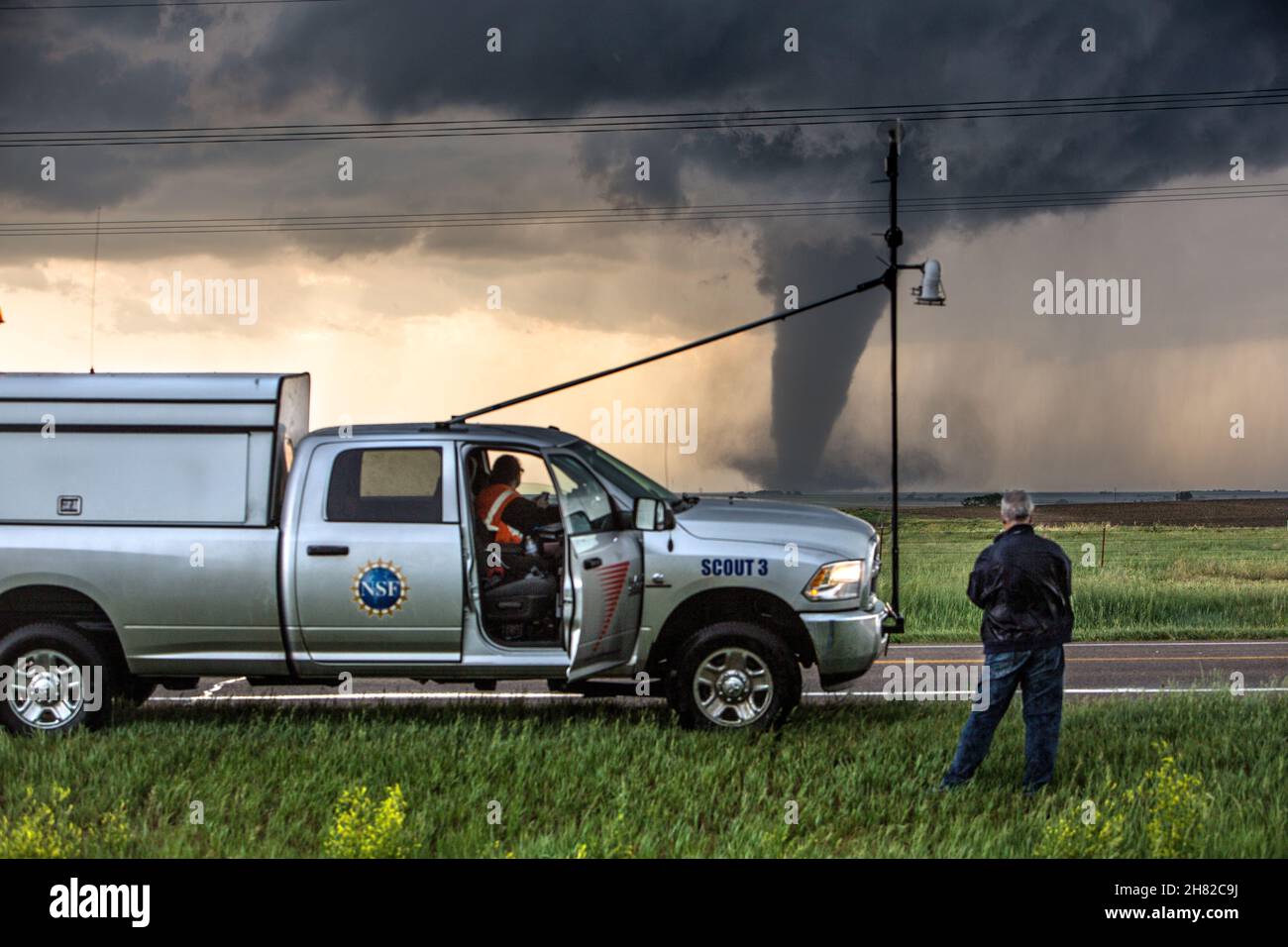 Storm Chasers Brandon Molyneaux and Tim Marshall observe a tornado  near Dodge City, Kansas, May 24, 2016. Stock Photo