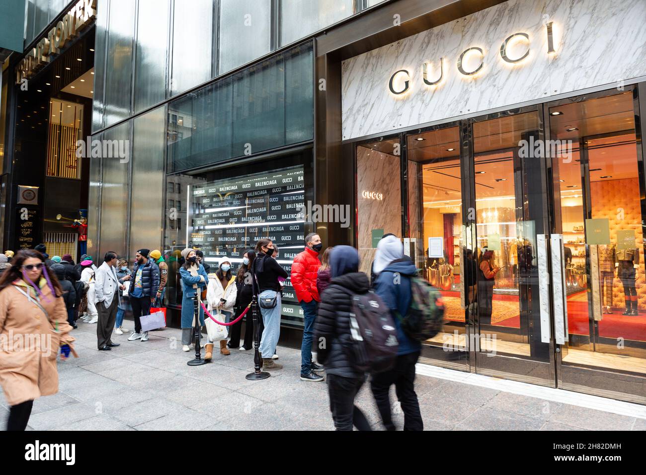 People shop in the Gucci department at a Saks Fifth Avenue store