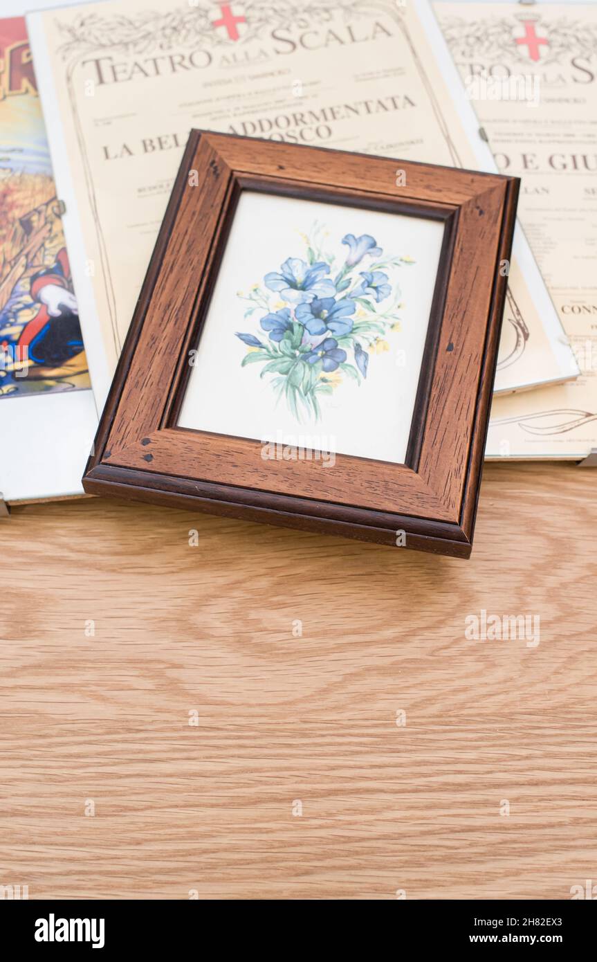glass clip frames with posters on a wooden tabletop background Stock