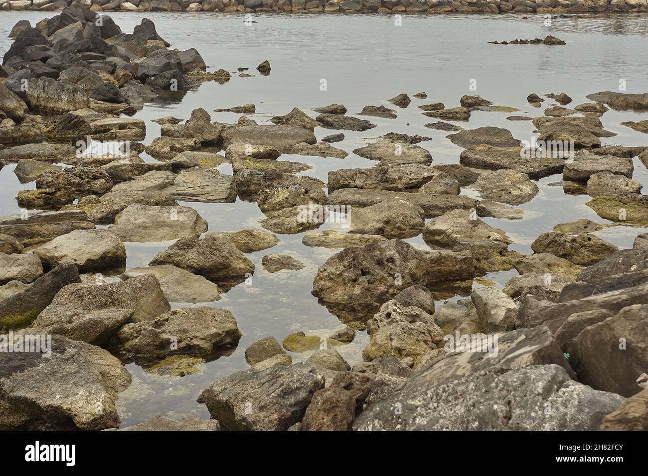 Shooting Rocks Beach The rocks in the water in wide-angle shooting Stock Photo - Alamy