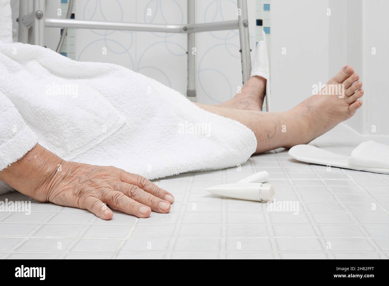 Elderly woman falling in bathroom because slippery surfaces Stock Photo