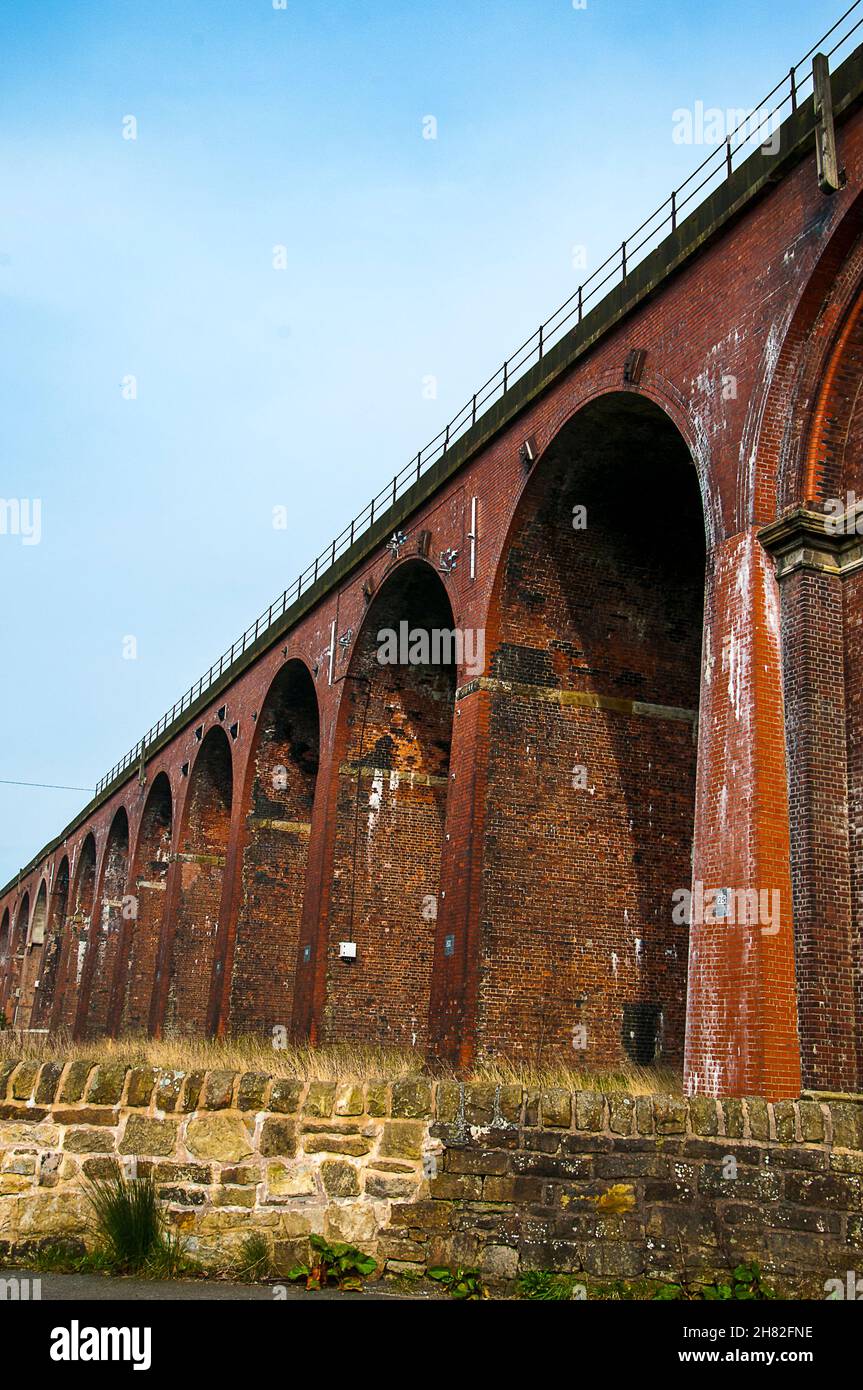 Whalley Viaduct is a 48-span railway bridge crossing the River Calder and a listed structure as seen from below. Stock Photo