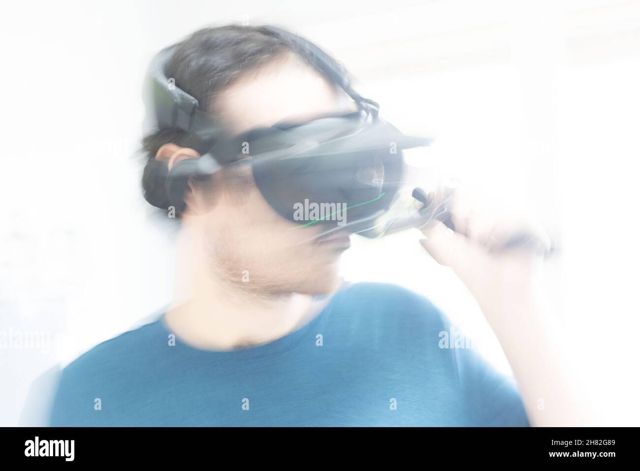 A young man gaming in virtual reality. Stock Photo