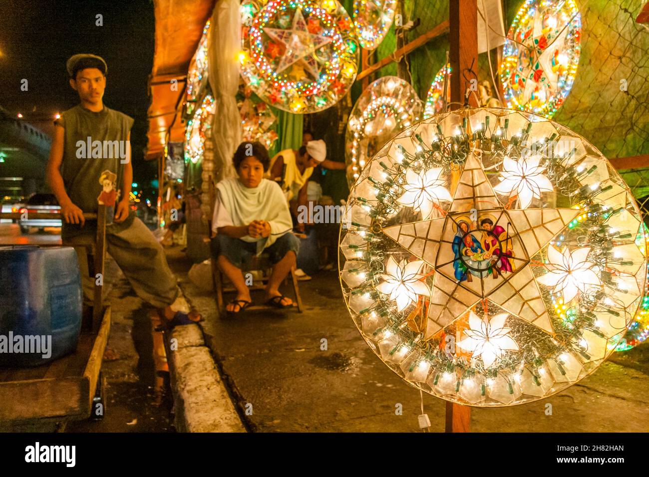 Vendors at a roadside christmas lantern shop waiting for customers in