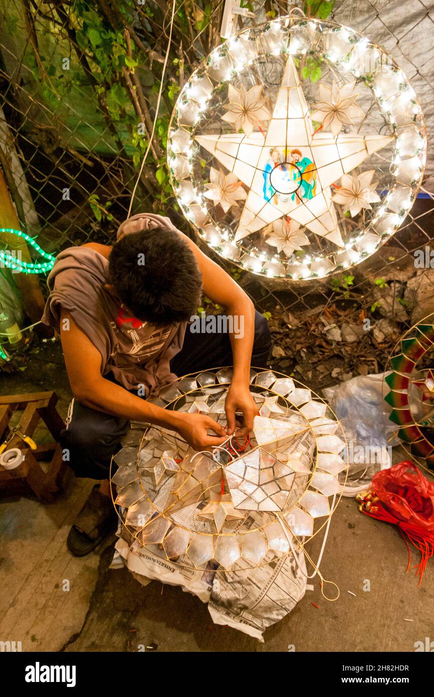 Filipino lantern maker working on a 'parol,' the traditional Christmas