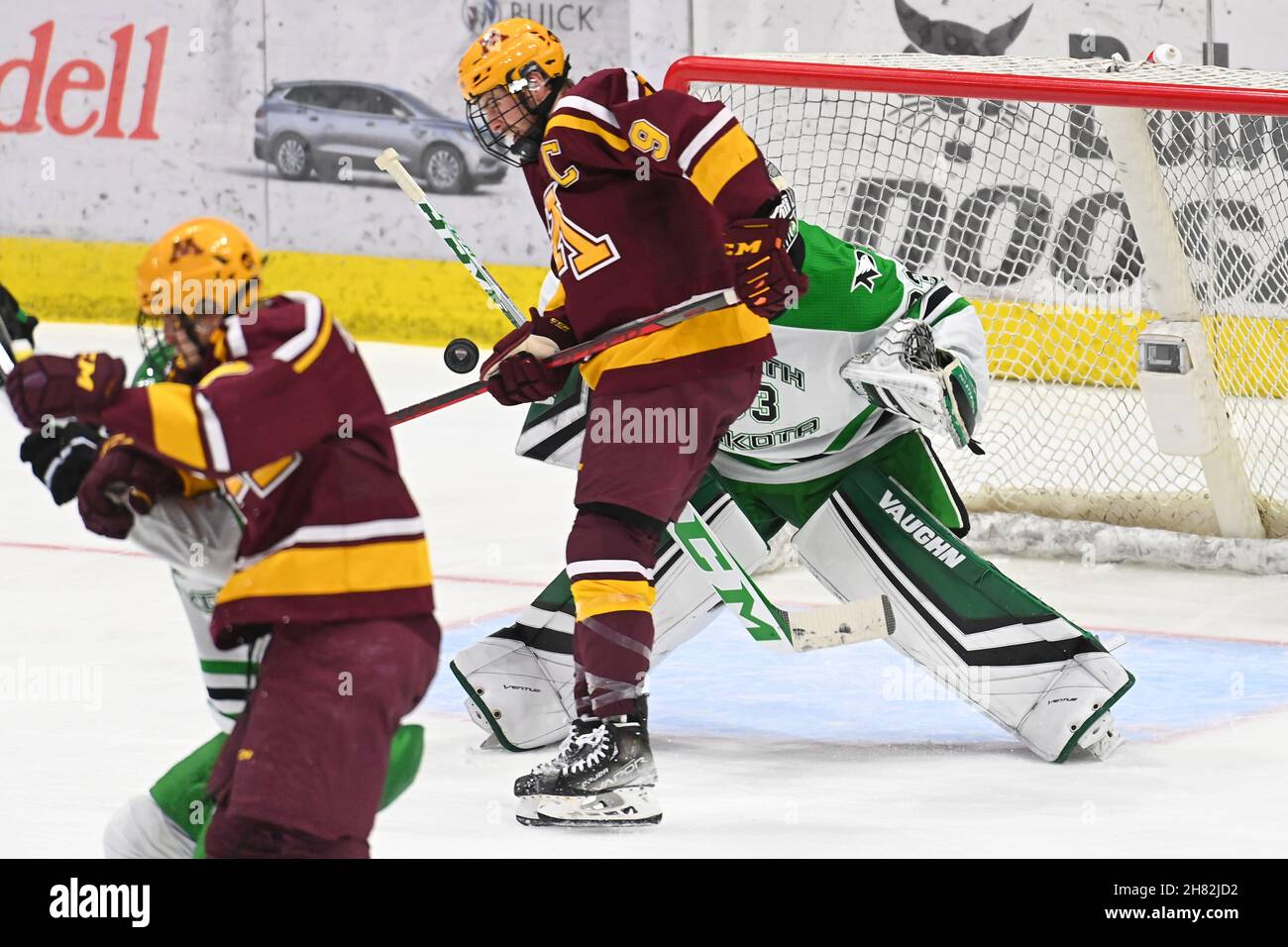 North Dakota, USA. 26th Nov, 2021. November 26, 2021 Minnesota Gophers forward Sammy Walker (9) attempts to deflect a puck towards North Dakota Fighting Hawks goaltender Zach Driscoll (33) during a NCAA men's hockey game between the Minnesota Gophers and the University of North Dakota Fighting Hawks at Ralph Engelstad Arena in Grand Forks, ND. By Russell Hons/CSM Credit: Cal Sport Media/Alamy Live News Stock Photo