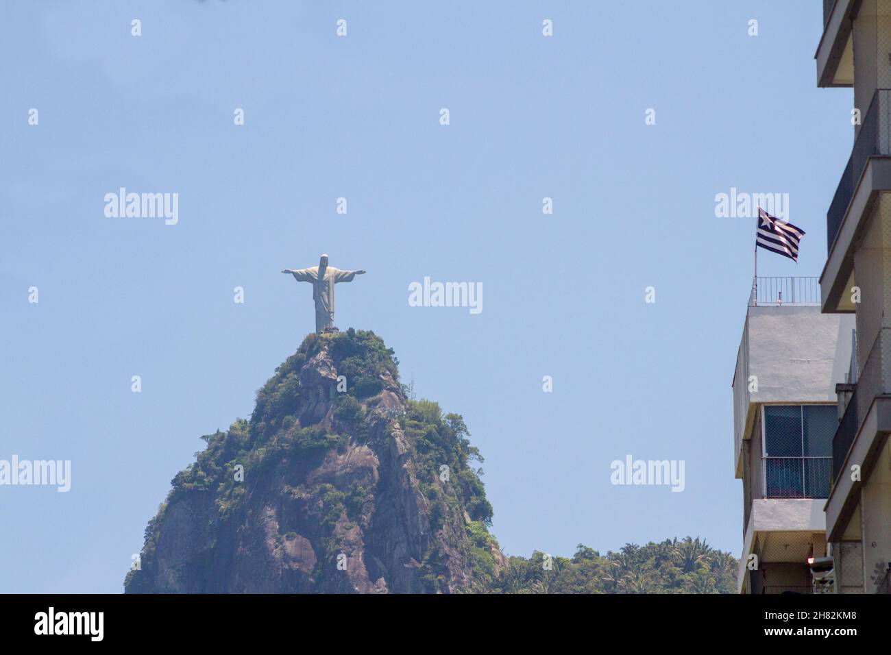 Christ the Redeemer and the Botafogo flag in Rio de Janeiro, Brazil - October 23, 2021: Christ the Redeemer with the Botafogo regatta club flag in Rio Stock Photo