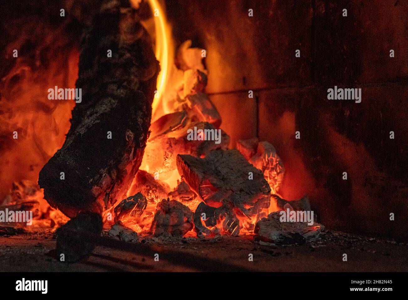 Wallpaper of a fire on a brick background. Stock Photo