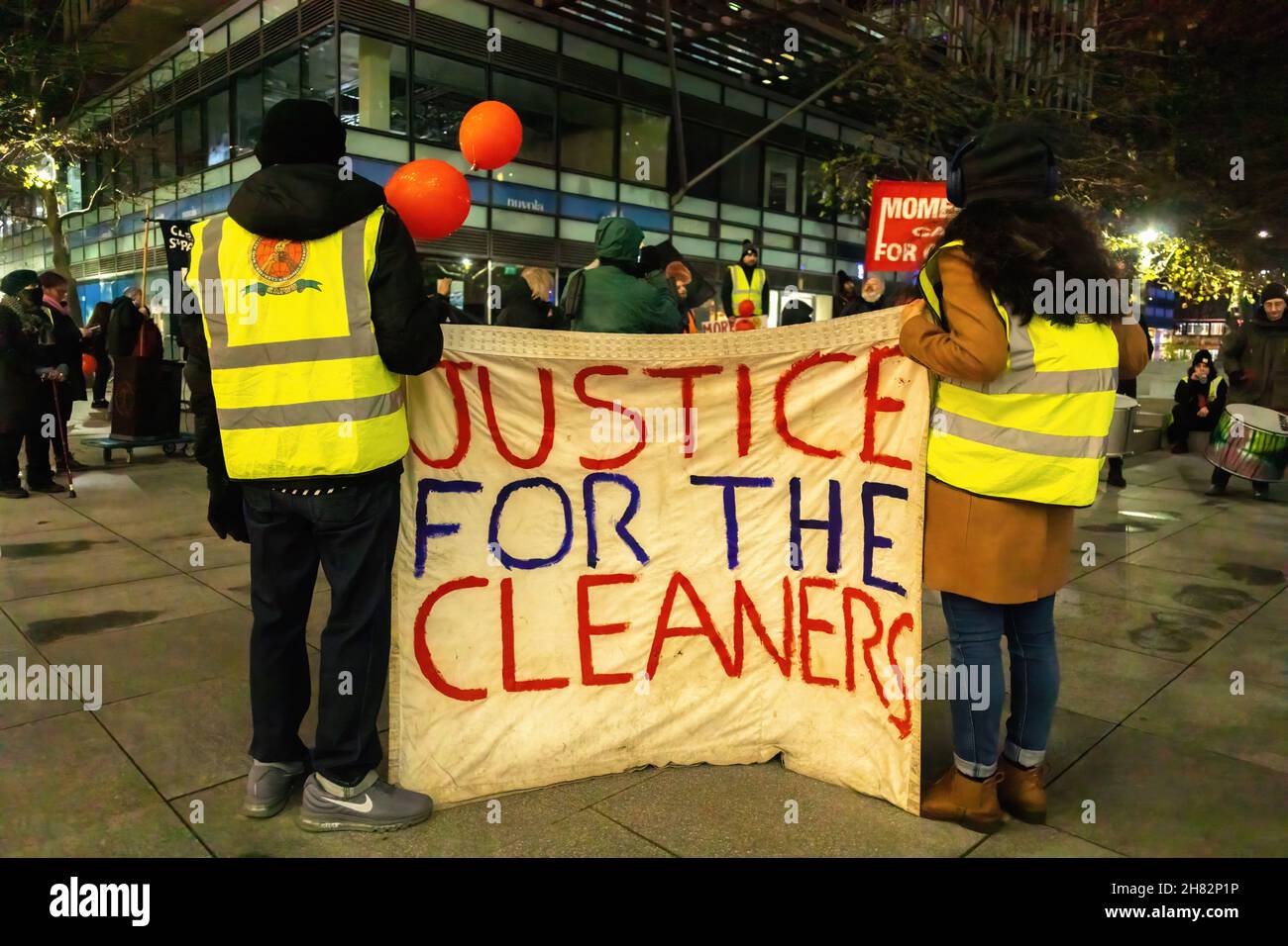 London, UK. 26th Nov, 2021. Protestors hold a banner that says 'Justice for the cleaners' during a protest outside Facebook headquarters at Warren Street in London.The group of protesters led by the Independent Workers Union protested at the Facebook London office after it increased workload without a salary increase. Jones Lang LaSalle (JLL) has outsourced the cleaning obligations to Churchill Services to clean the office of Facebook. Also, they allegedly mistreated the cleaners which resulted in the protest. Credit: SOPA Images Limited/Alamy Live News Stock Photo
