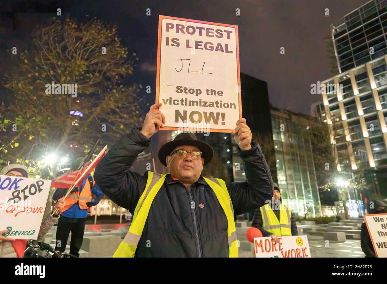 A protestor is seen holding a placard that says 'protest is legal, JLL stop the victimization now!' during a protest outside Facebook headquarters at Warren Street in London.The group of protesters led by the Independent Workers Union protested at the Facebook London office after it increased workload without a salary increase. Jones Lang LaSalle (JLL) has outsourced the cleaning obligations to Churchill Services to clean the office of Facebook. Also, they allegedly mistreated the cleaners which resulted in the protest. (Photo by Belinda Jiao/SOPA Images/Sipa USA) Stock Photo