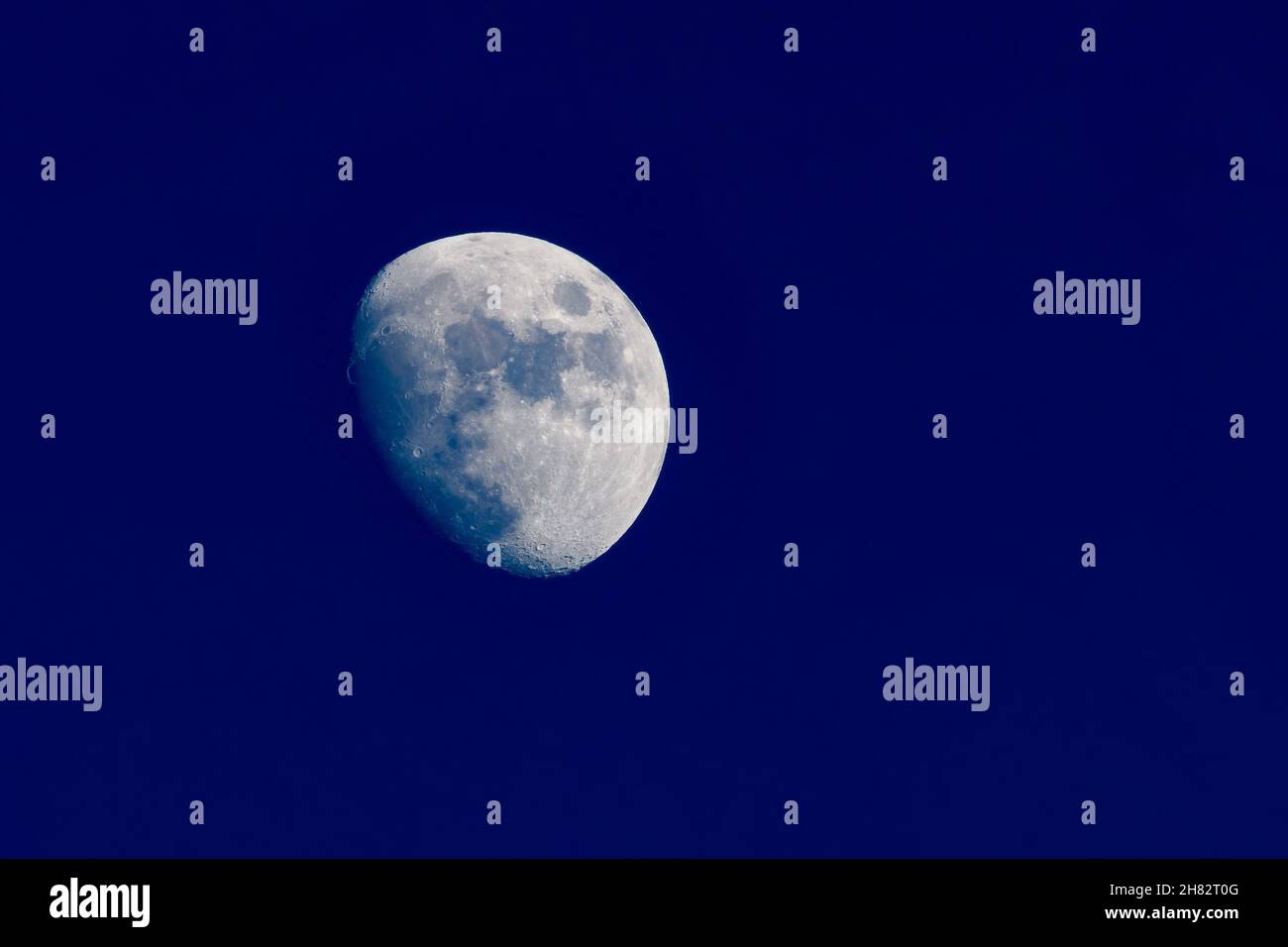 Clear image of waxing gibbous moon on clear blue evening. Stock Photo