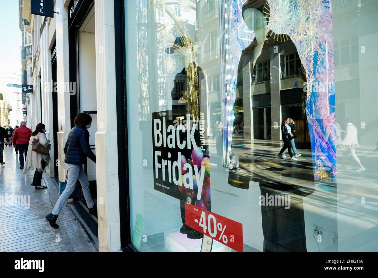 Malaga Spain. 26th Nov 2021. Mannequins are seen behind the Black Friday sale sticker at Pull and Bear store in Malaga.In 2021 online commerce has grown by 71 after consumers fear crowds
