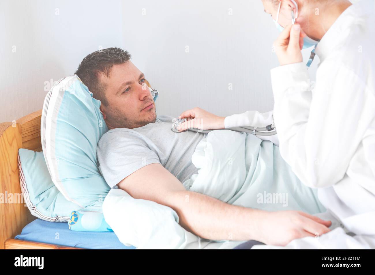 Doctor use stethoscope, checking up heart beat. Patient worker has to ...