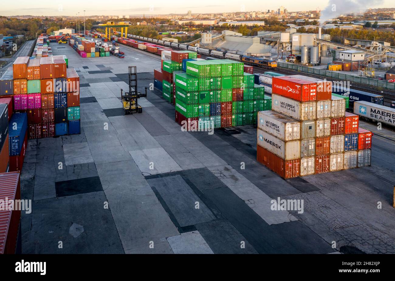 Aerial view of a busy shipping container rail terminal in Leeds with shipping containers waiting to be loaded onto road and rail transport Stock Photo