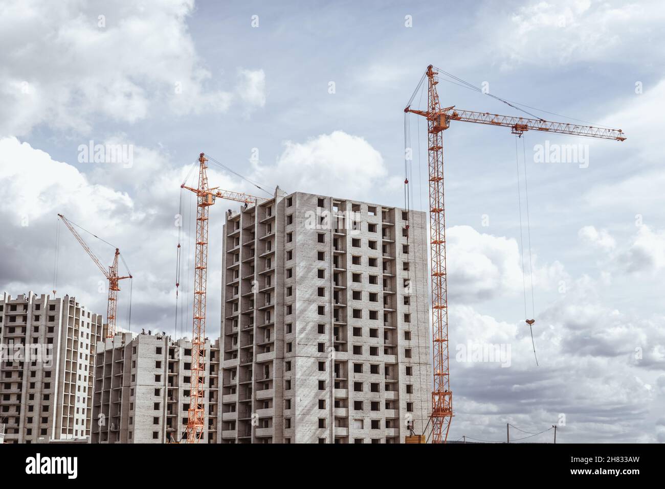 Huge cranes working on construction site Stock Photo