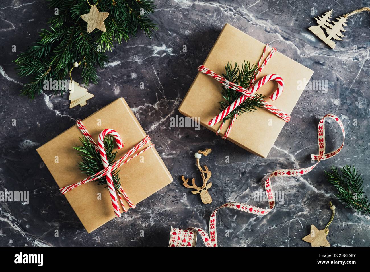 Christmas gift boxes decorated with evergreen branches and candy canes ...