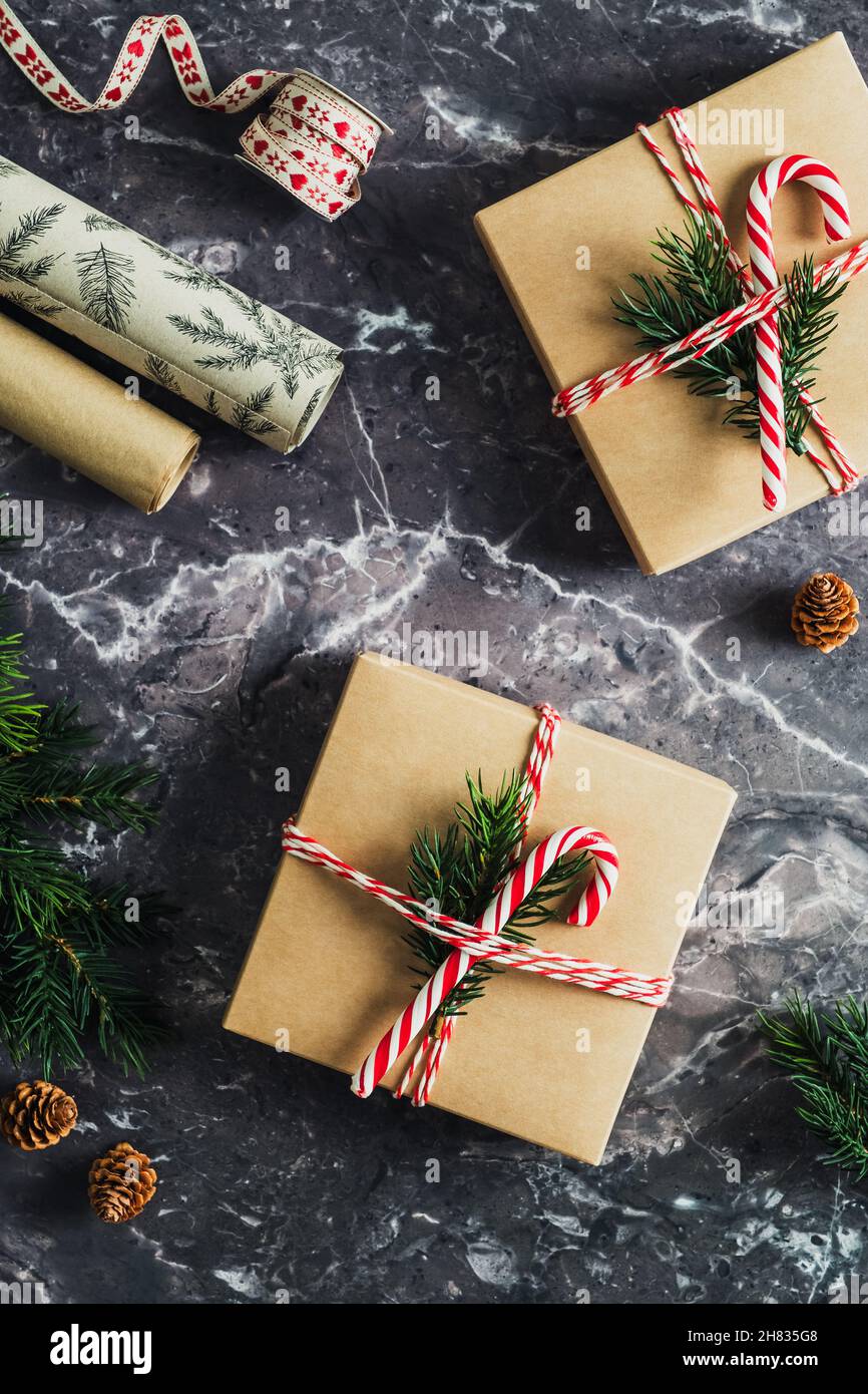 Flat lay concept for Christmas gift wrapping with beautiful red and white  striped gift box with big red bow, wrapping paper, ribbons, and decoration  l Stock Photo - Alamy