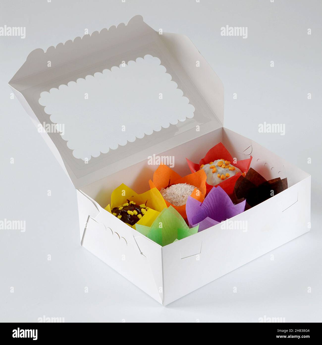 Box with tulip forms, confectionery object isolated over white background Stock Photo