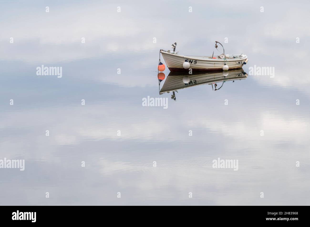 Boat on the calm waters of Old Dornie amd Enard Bay near Ullapool, Scottish Highlands, Scotland Stock Photo