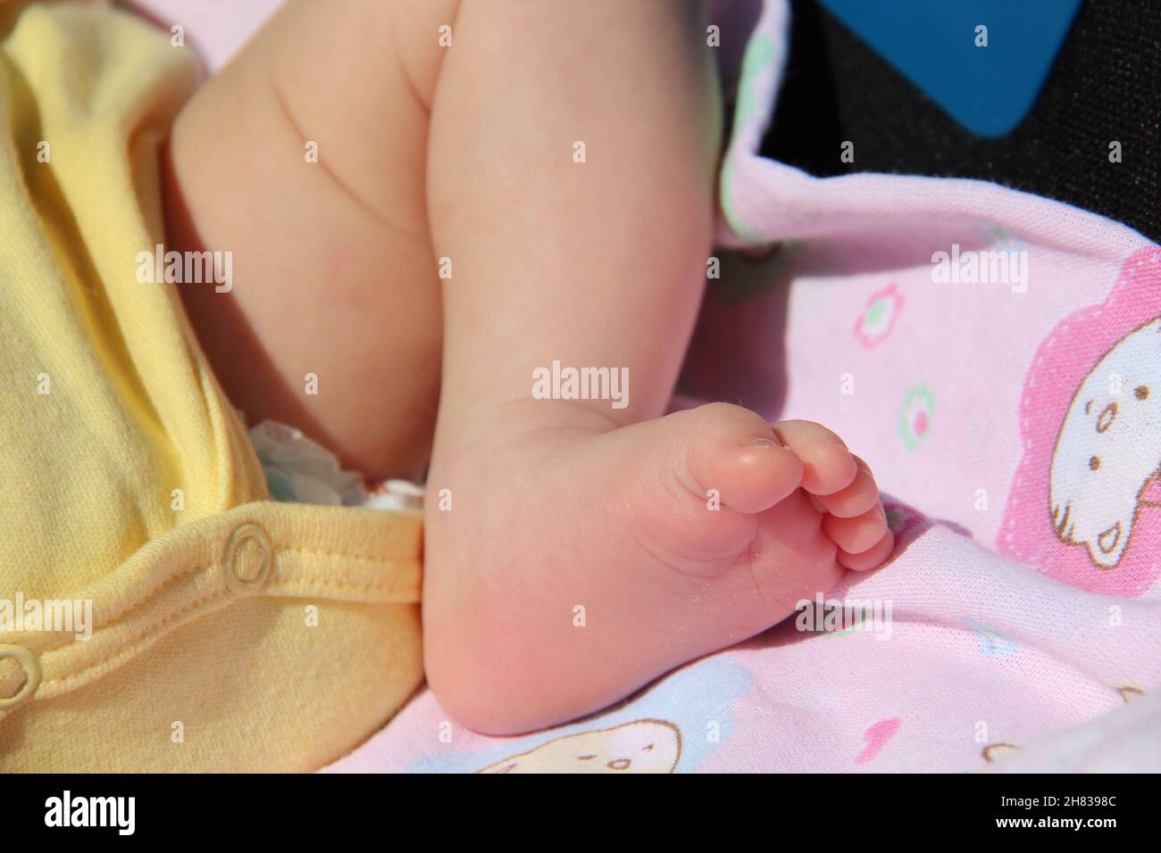 Foot of a newborn baby is sunbathing. Health, treatment, dermatology, childhood, summer, rest, tours. Stock Photo