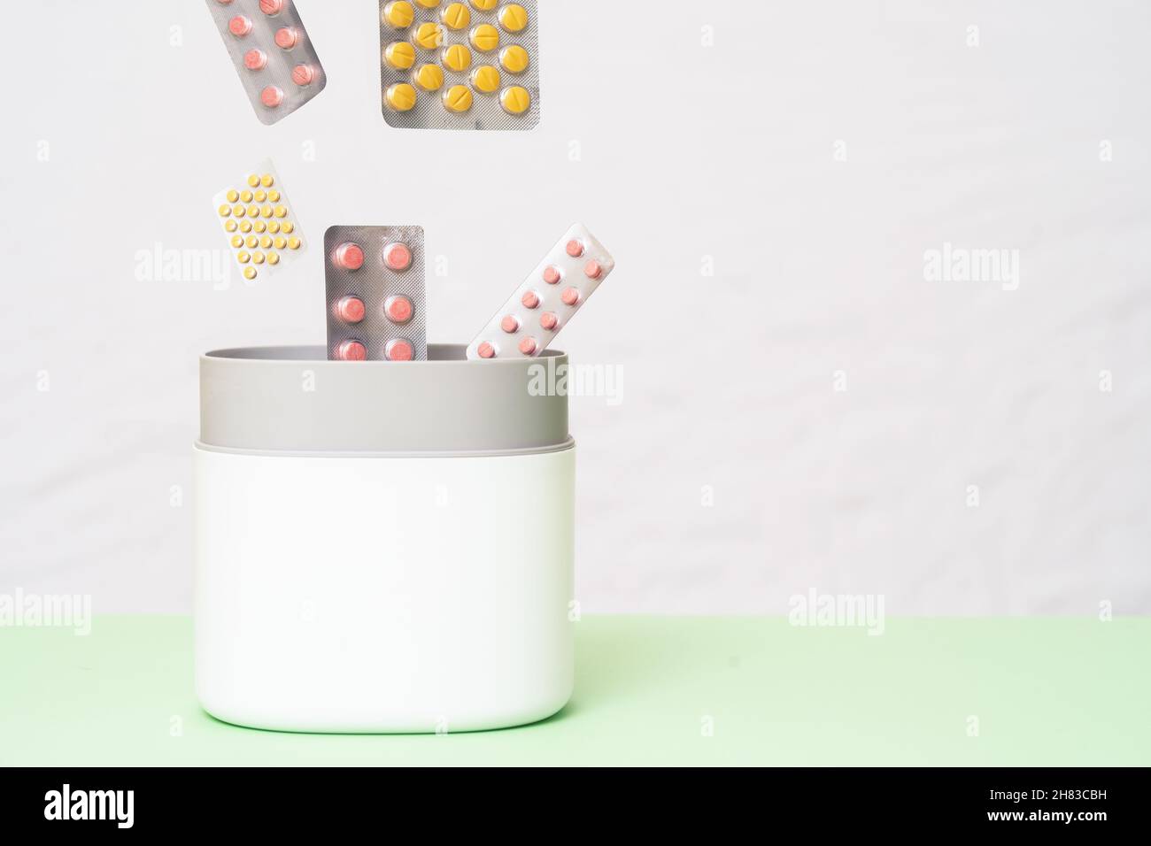 Close up photo of trash bin with full of pills and medicines. Expired pills and medicines are being gathered to be recycled. Waste management concept. Stock Photo