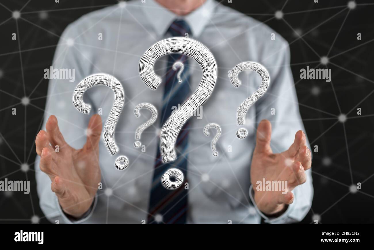 Question concept between hands of a man in background Stock Photo