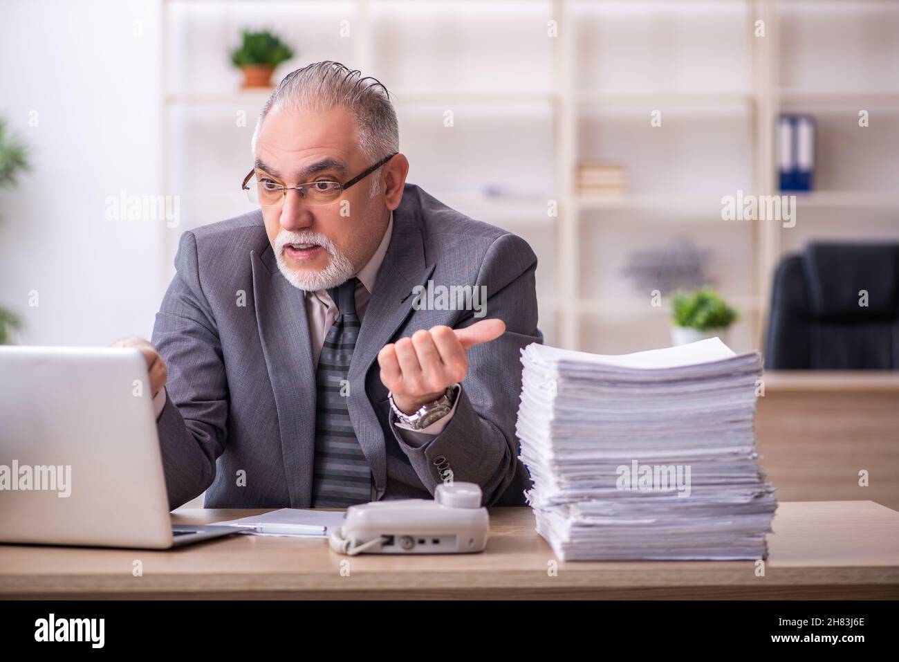 Old businessman employee working at workplace Stock Photo - Alamy