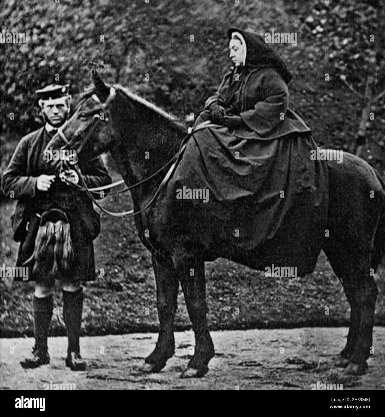 Queen Victoria with  her 'companion' John Brown on her horse 'Fyvie' taken at Balmoral in 1863 by George Wilson (1823-1893) from the archives of Press Portrait Service (Formerly Press Portrait Bureau). Stock Photo