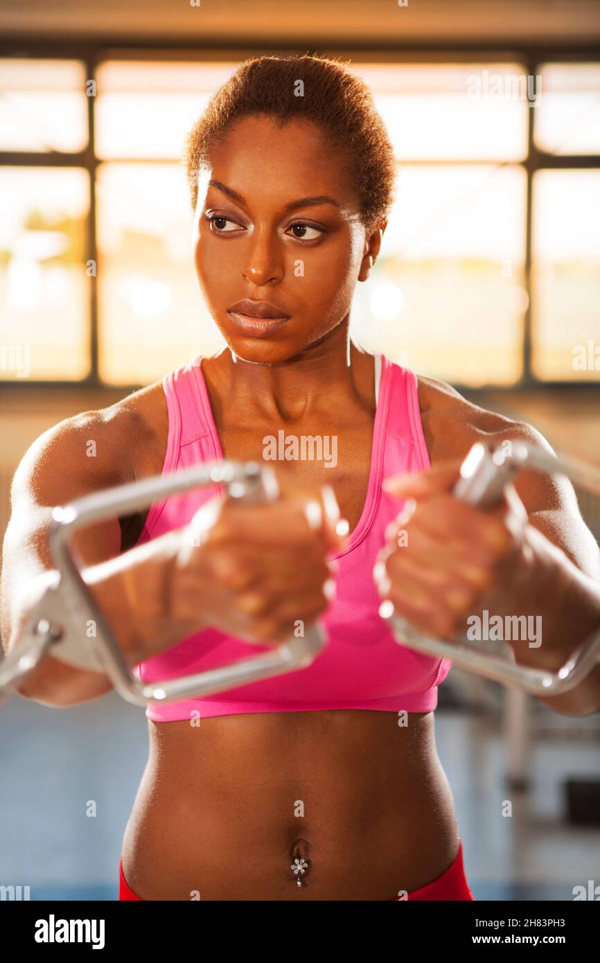 fit black female train in the gym on fitness equipment Stock Photo