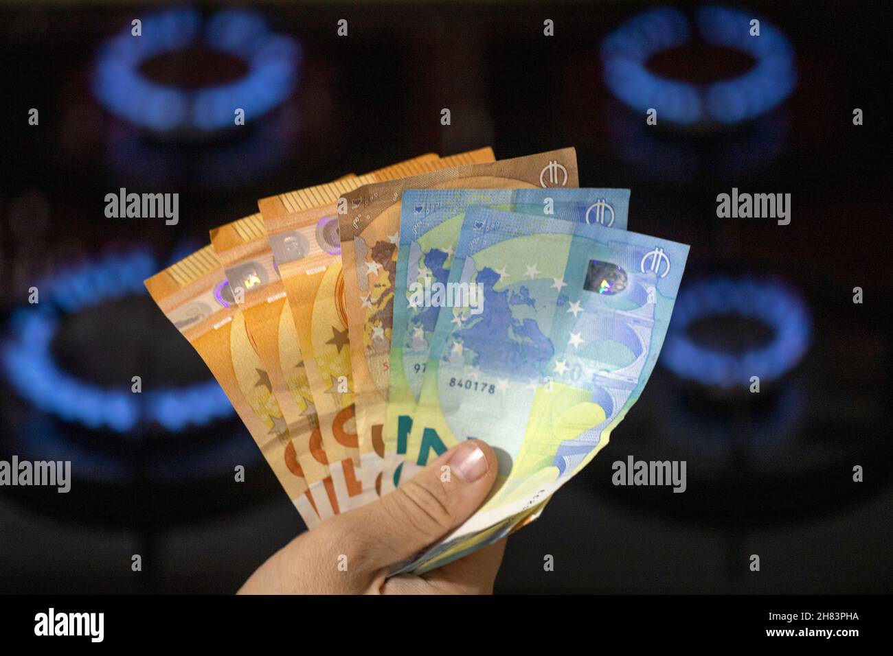 European energy crisis. increase in gas prices in Europe for the population. euro banknotes in front of the burning gas stove Stock Photo