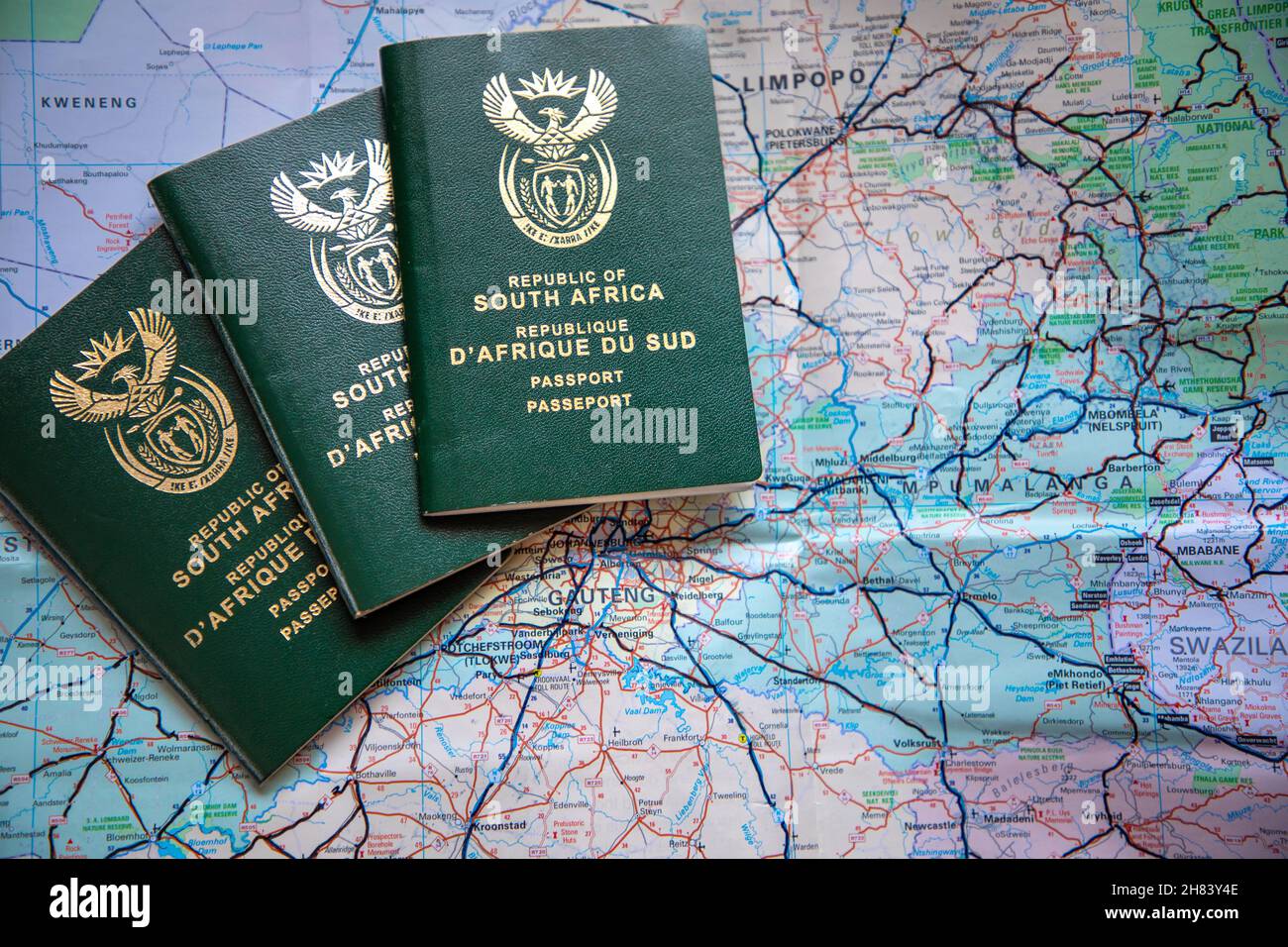 Three South African passports agains a map of South Africa. Concept for covid travel