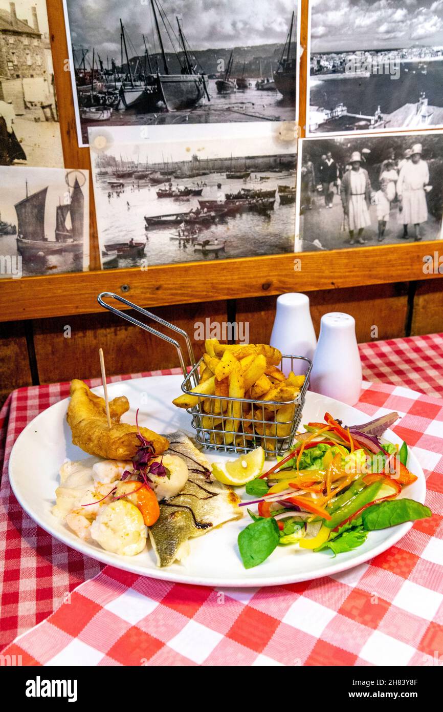 The Mermaid fish platter with bass, scallops, tiger prawns, lemon sole and battered cod with chips, The Mermaid seafood restaurant, St Ives, Cornwall, Stock Photo