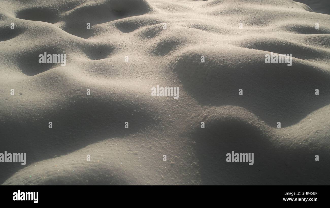 Sunlit snow cover with shadows Stock Photo