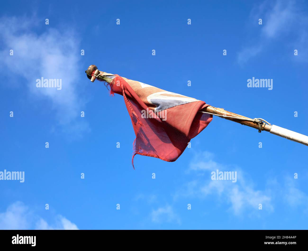 Tatty union jack flag on a pole Stock Photo