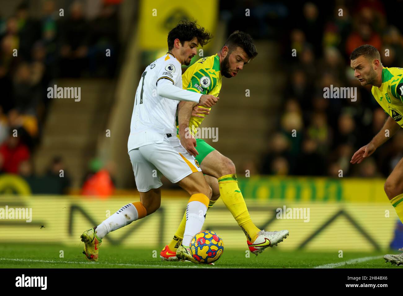 Carrow Road, Norwich, Norforlk, UK. 27th Nov, 2021. Premier League football, Norwich versus Wolverhampton Wanderers; Trinc&#xe3;o of Wolverhampton Wanderers competes for the ball with Grant Hanley of Norwich City Credit: Action Plus Sports/Alamy Live News Stock Photo