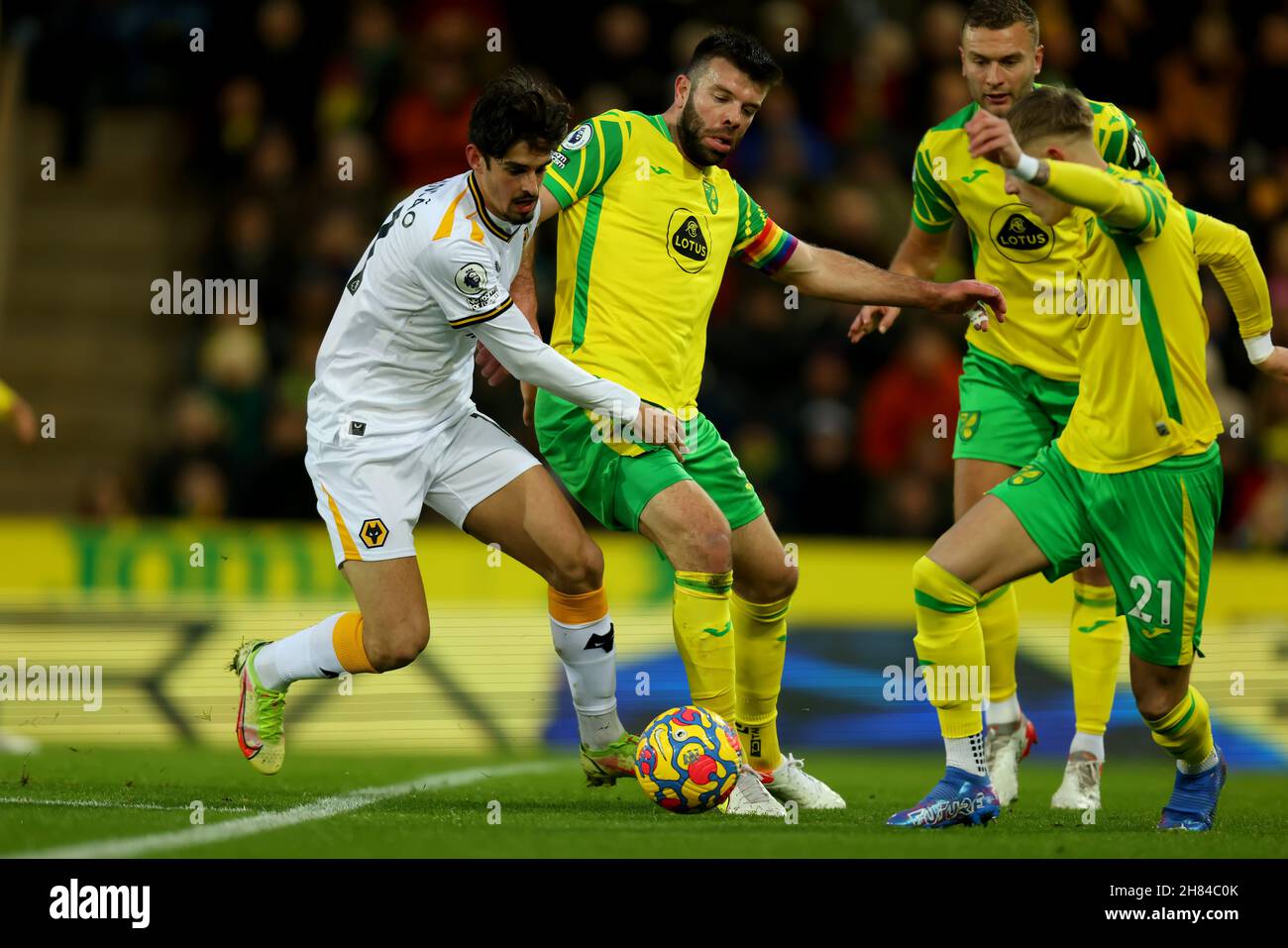 Carrow Road, Norwich, Norforlk, UK. 27th Nov, 2021. Premier League football, Norwich versus Wolverhampton Wanderers; Trinc&#xe3;o of Wolverhampton Wanderers competes for the ball with Grant Hanley of Norwich City Credit: Action Plus Sports/Alamy Live News Stock Photo