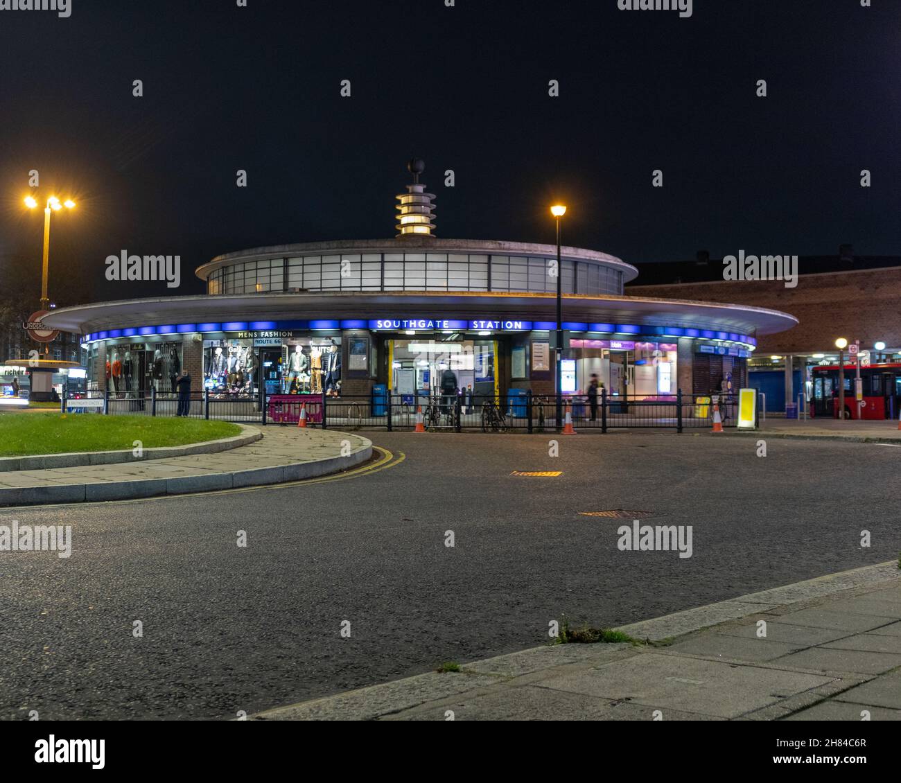 A night shot of Southgate tube station with the road in the foreground. The station is an Art Deco station designed by Charles holden. Piccadilly line Stock Photo