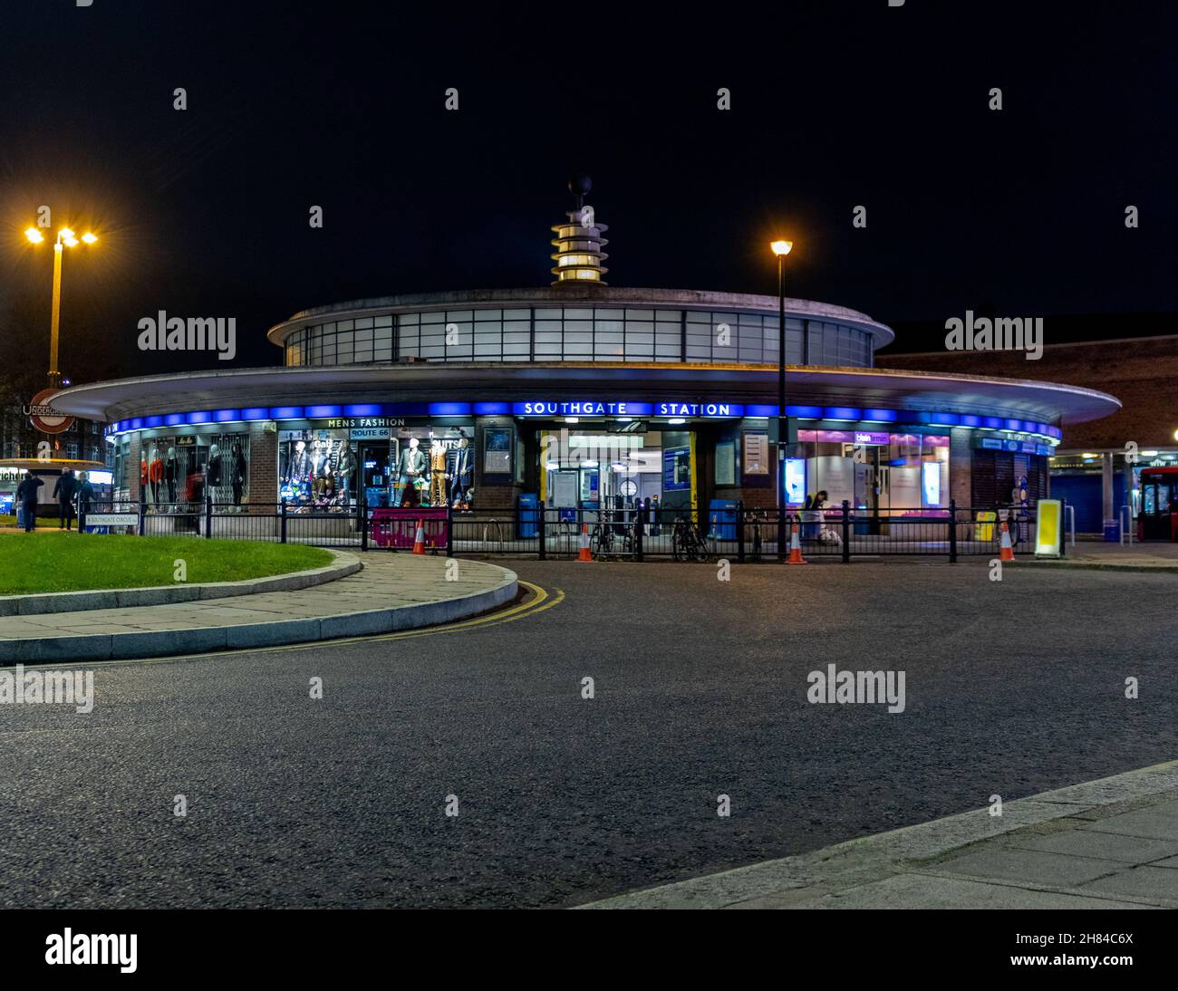 A night shot of Southgate tube station with the road in the foreground. The station is an Art Deco station designed by Charles holden. Piccadilly line Stock Photo