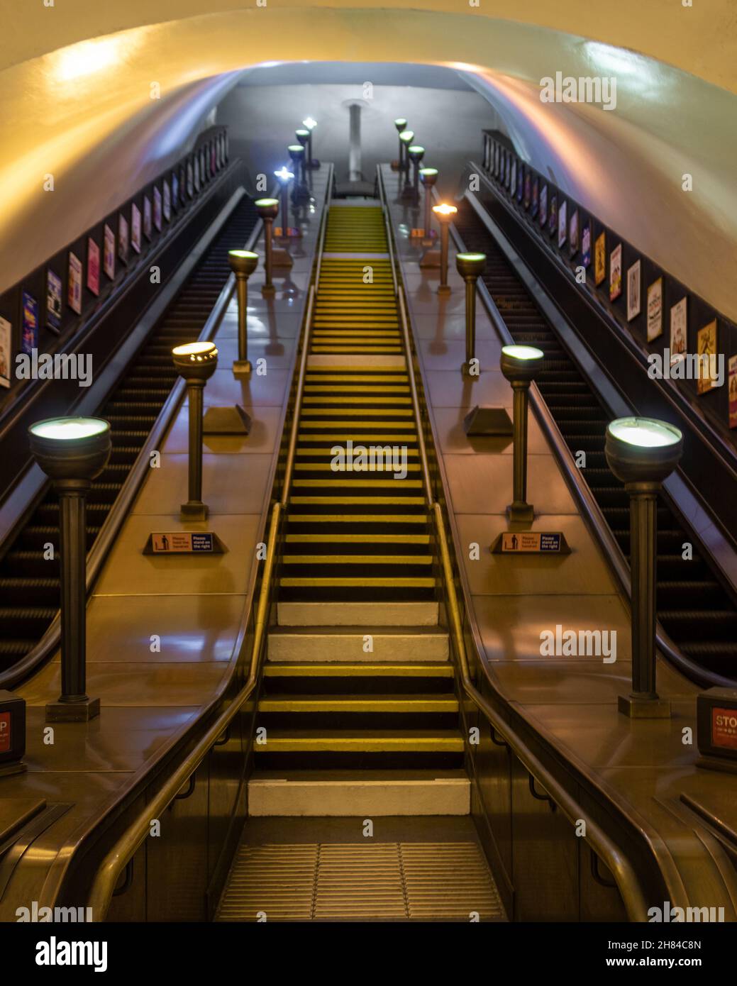 Escalators at Southgate tube station on the piccadilly line of the London underground network with Art Deco lighting and design. Stock Photo