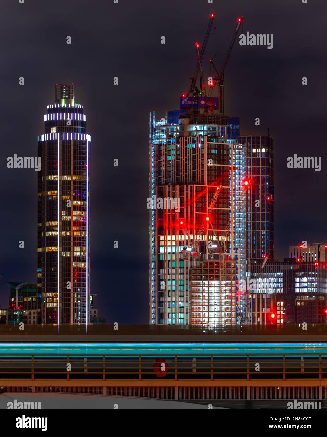 A train speeding into the station in London with the new development at Battersea and Nine Elms in the background. Stock Photo