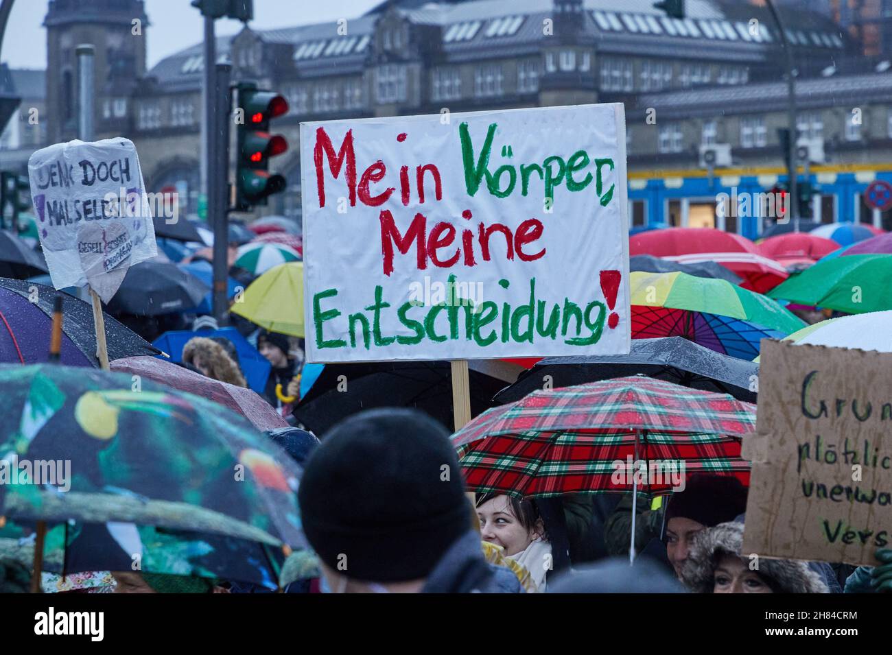 Hamburg, Germany. 27th Nov, 2021. A participant of a demonstration of Corona vaccination opponents on the Glockengießerwall holds a banner with the inscription 'My body, my decision!'. Credit: Georg Wendt/dpa/Alamy Live News Stock Photo
