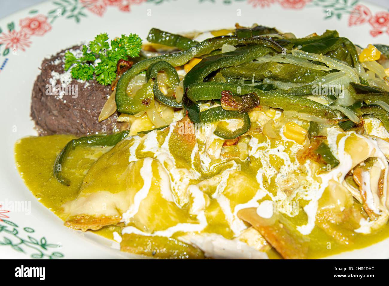 Traditional mexican dish called chilaquiles with fried tortillas, sauce