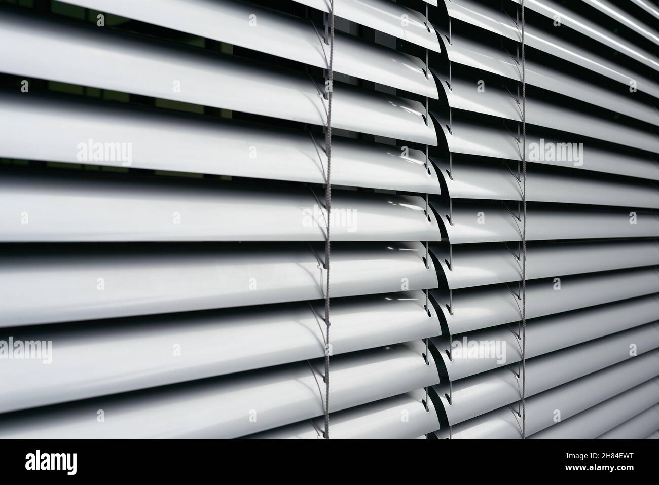 Blinds as sun protection on the window of an office building in Berlin in germany Stock Photo