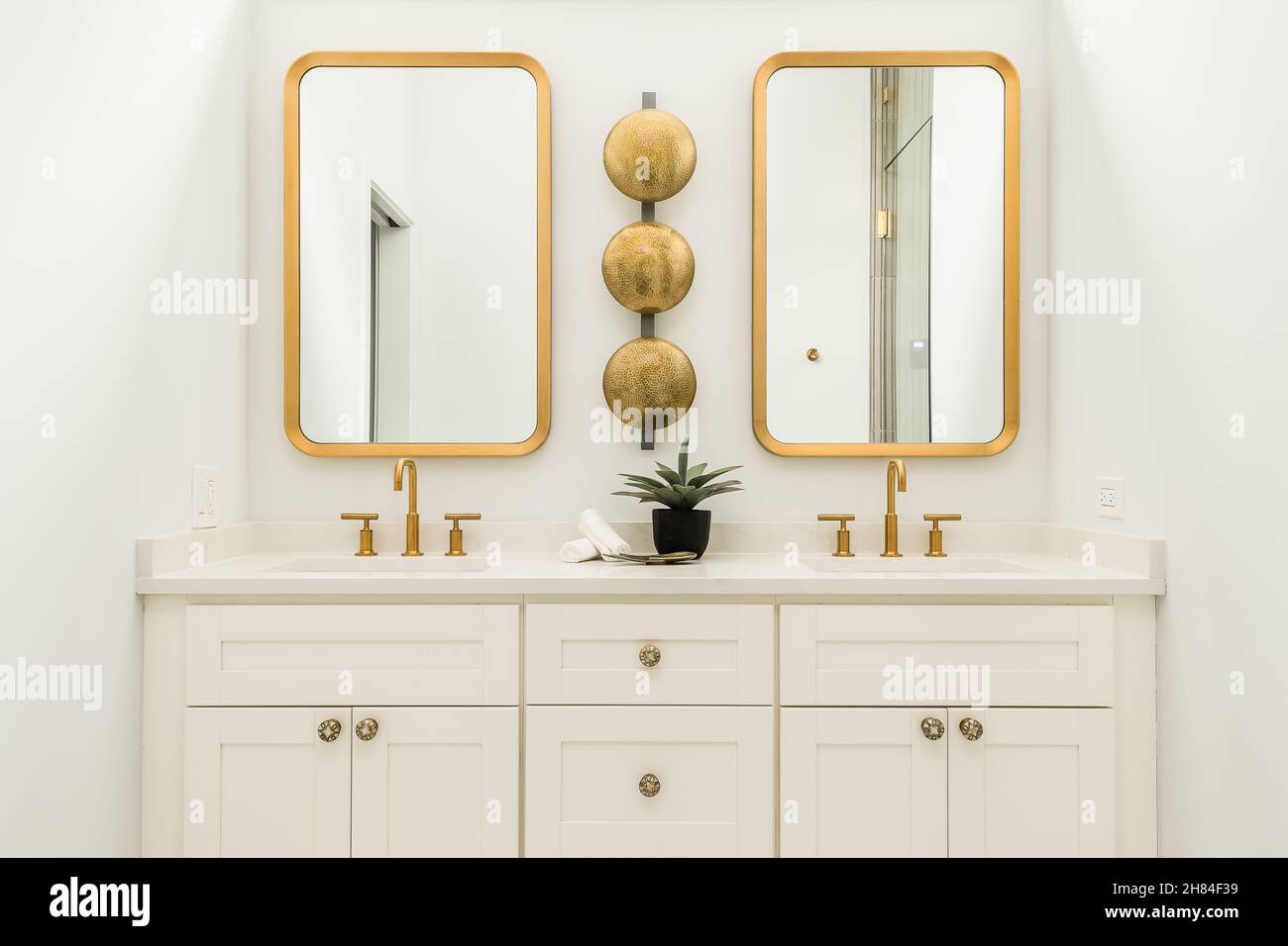 Modern White Bathroom with Gold Fixtures and Mirror Interior Design