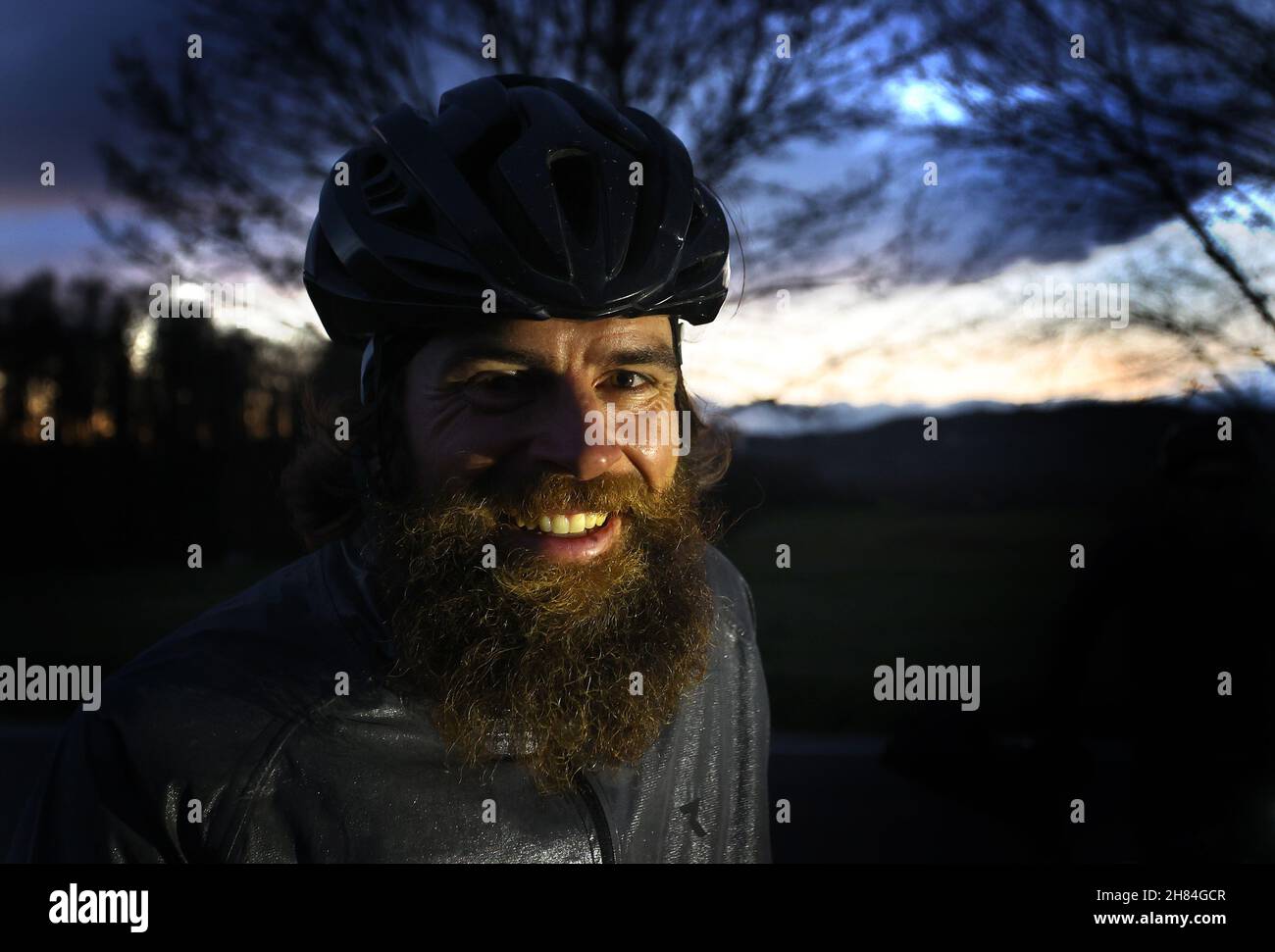 Singen, Germany. 27th Nov, 2021. Extreme athlete Jonas Deichmann stands on a dirt road with his bike after crossing the border from Switzerland. in Baden-Württemberg after his triathlon around the