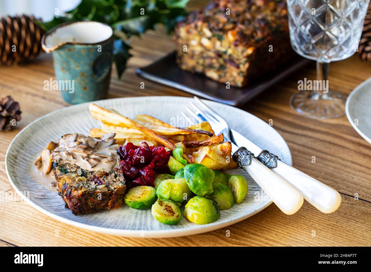 Vegetarian Christmas dinner with nut roast, mushroom sauce, roast parsnips and brussel sprouts