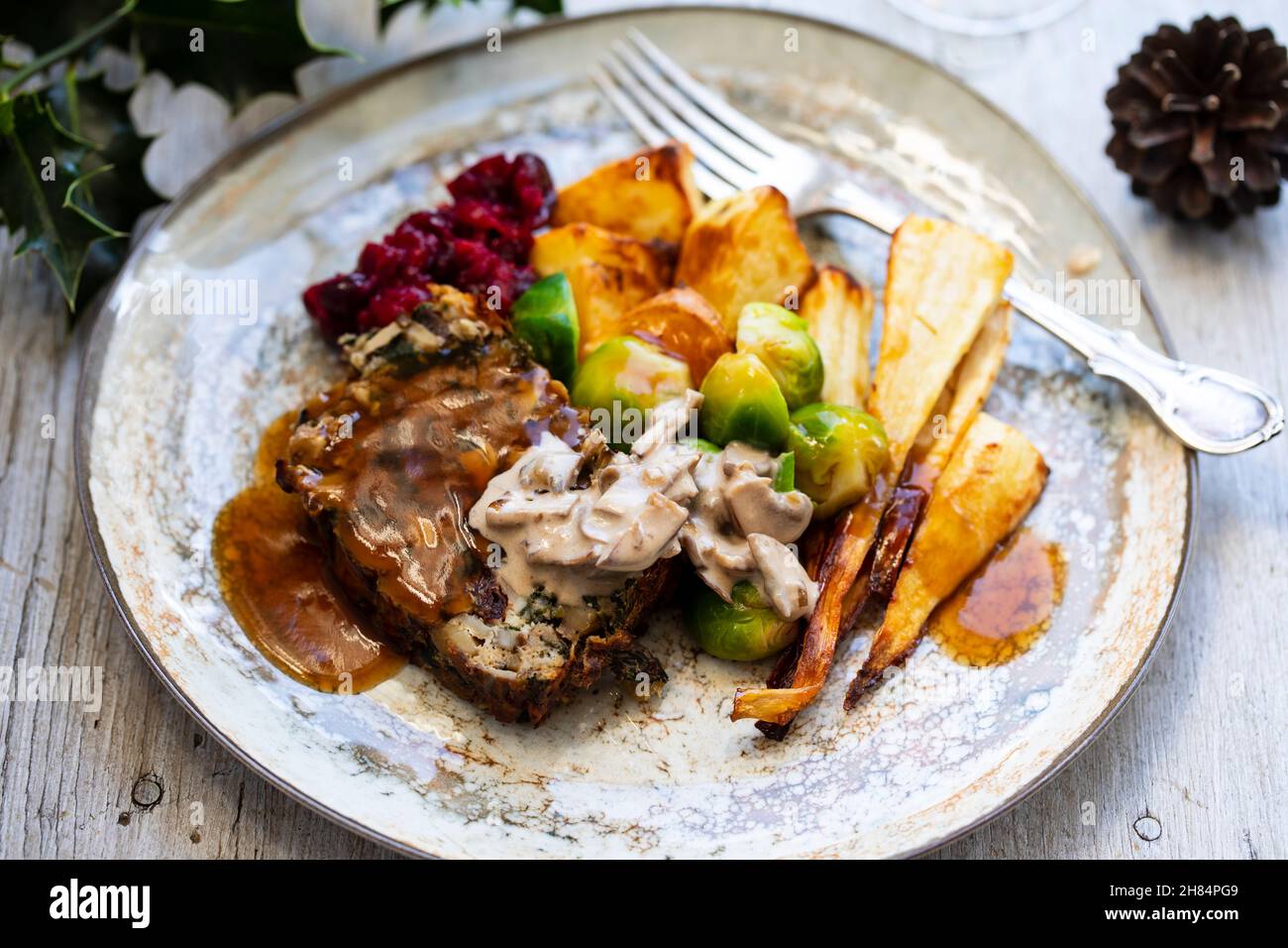 Vegetarian Christmas dinner with nut roast, mushroom sauce, roast