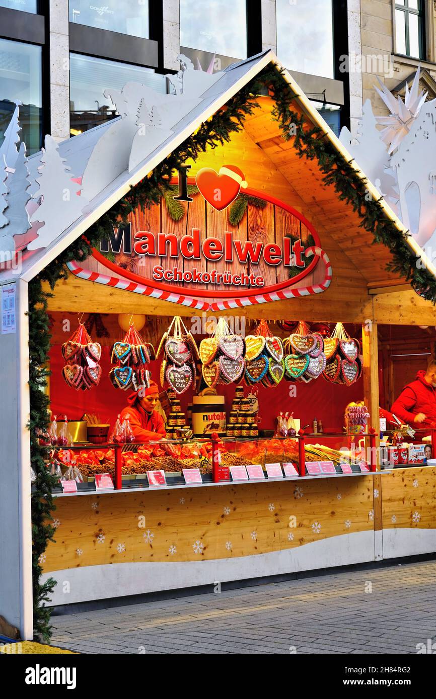 Christmas market booth selling sweets at the Christmas market 2021 in downtown Düsseldorf/Germany. Stock Photo